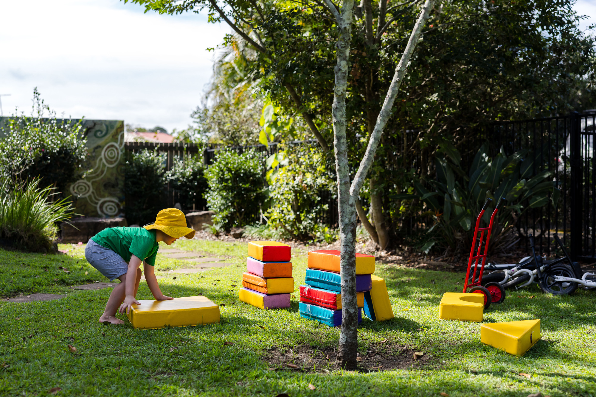 C&K Beachmere - child playing with soft play blocks outside