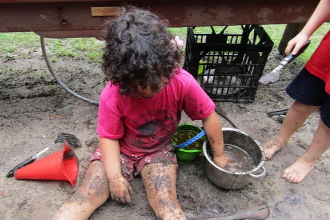 Bribie Island Kindy - child playing in the mud kitchen