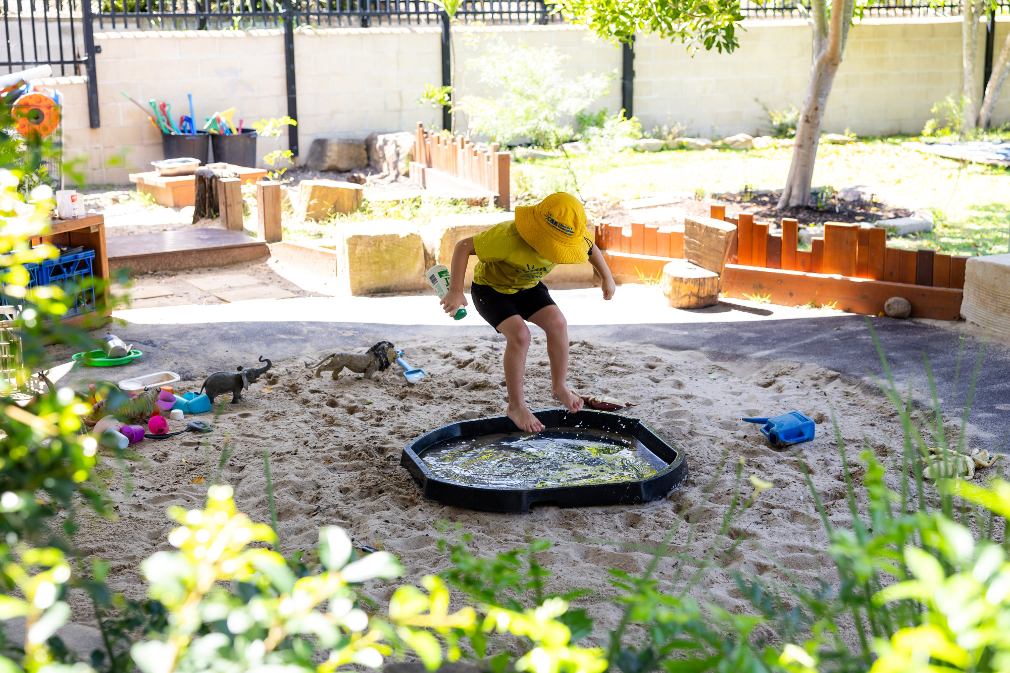 C&K Calamvale - child splashing in the sand pit