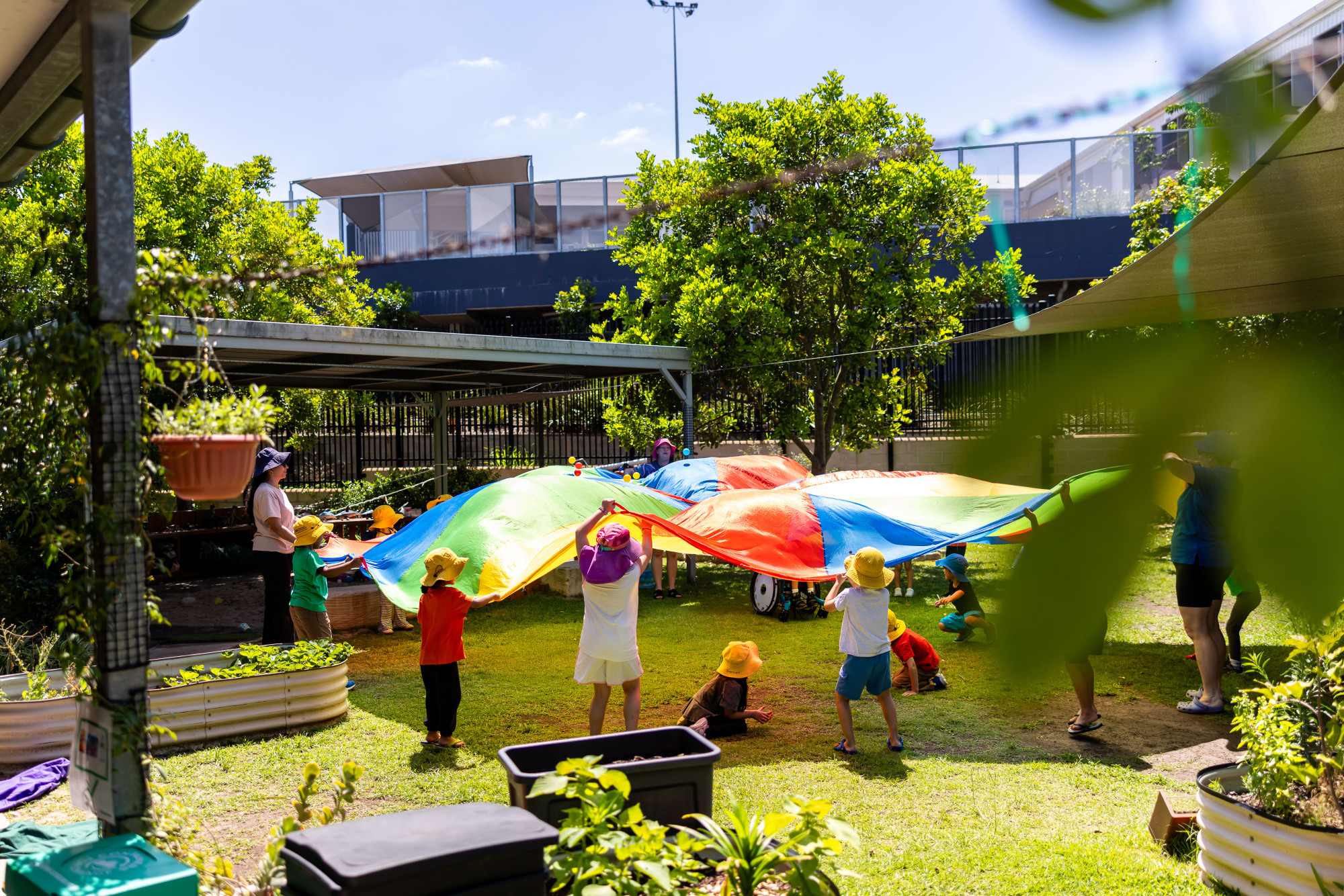 C&K Calamvale - children playing under a colourful parachute
