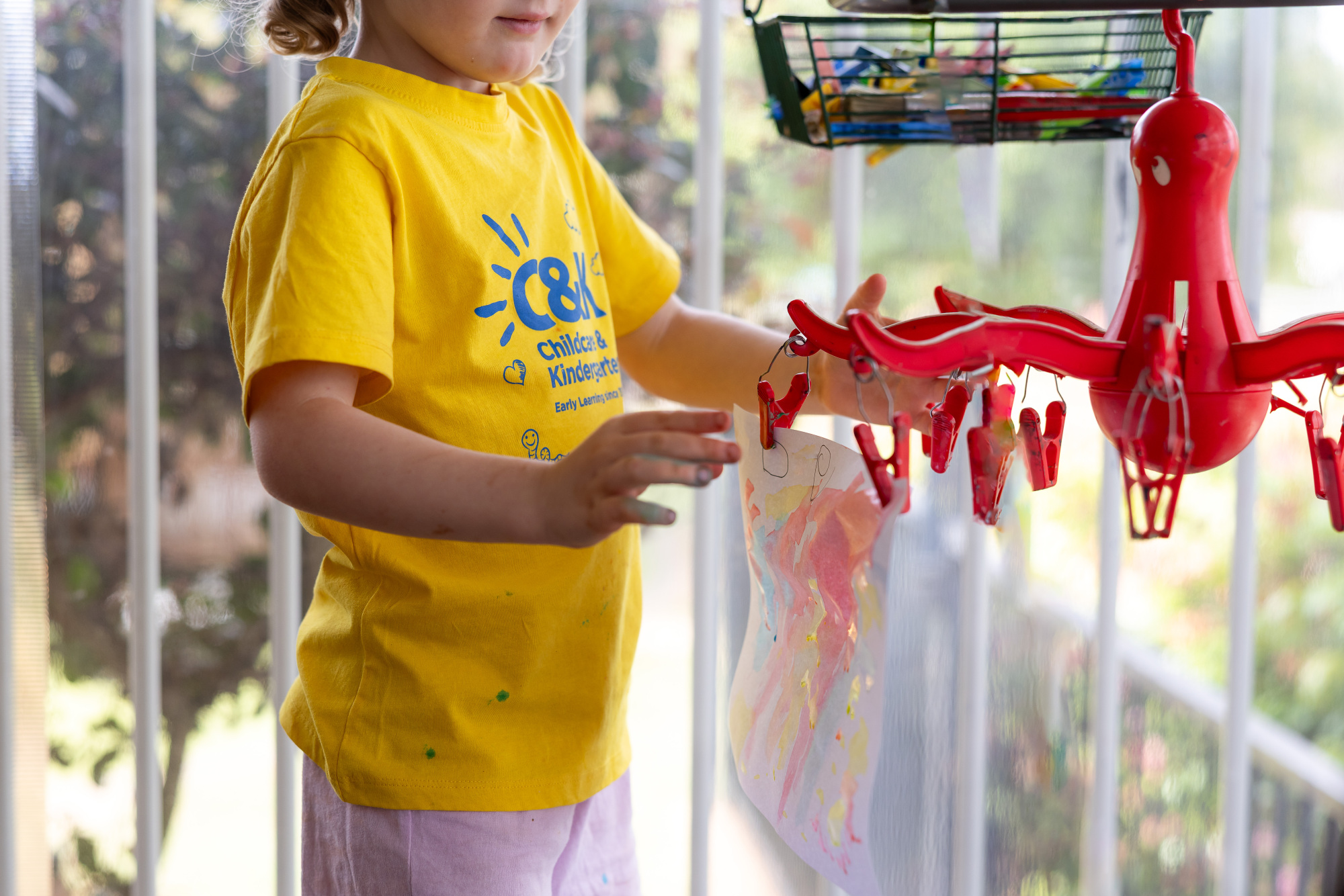 C&K Fairview Heights - child hanging up artwork