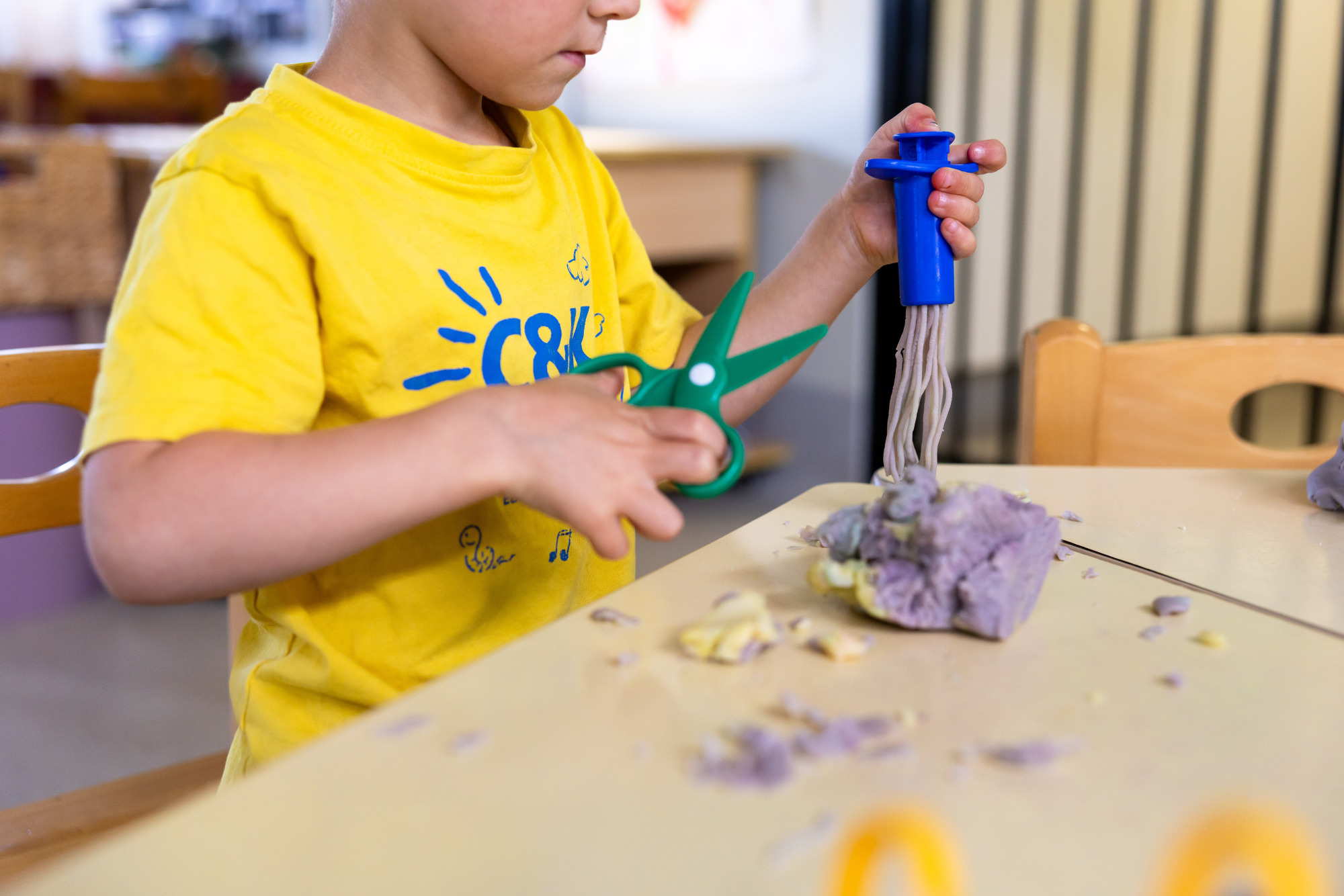 C&K Fairview Heights - child cutting playdoh