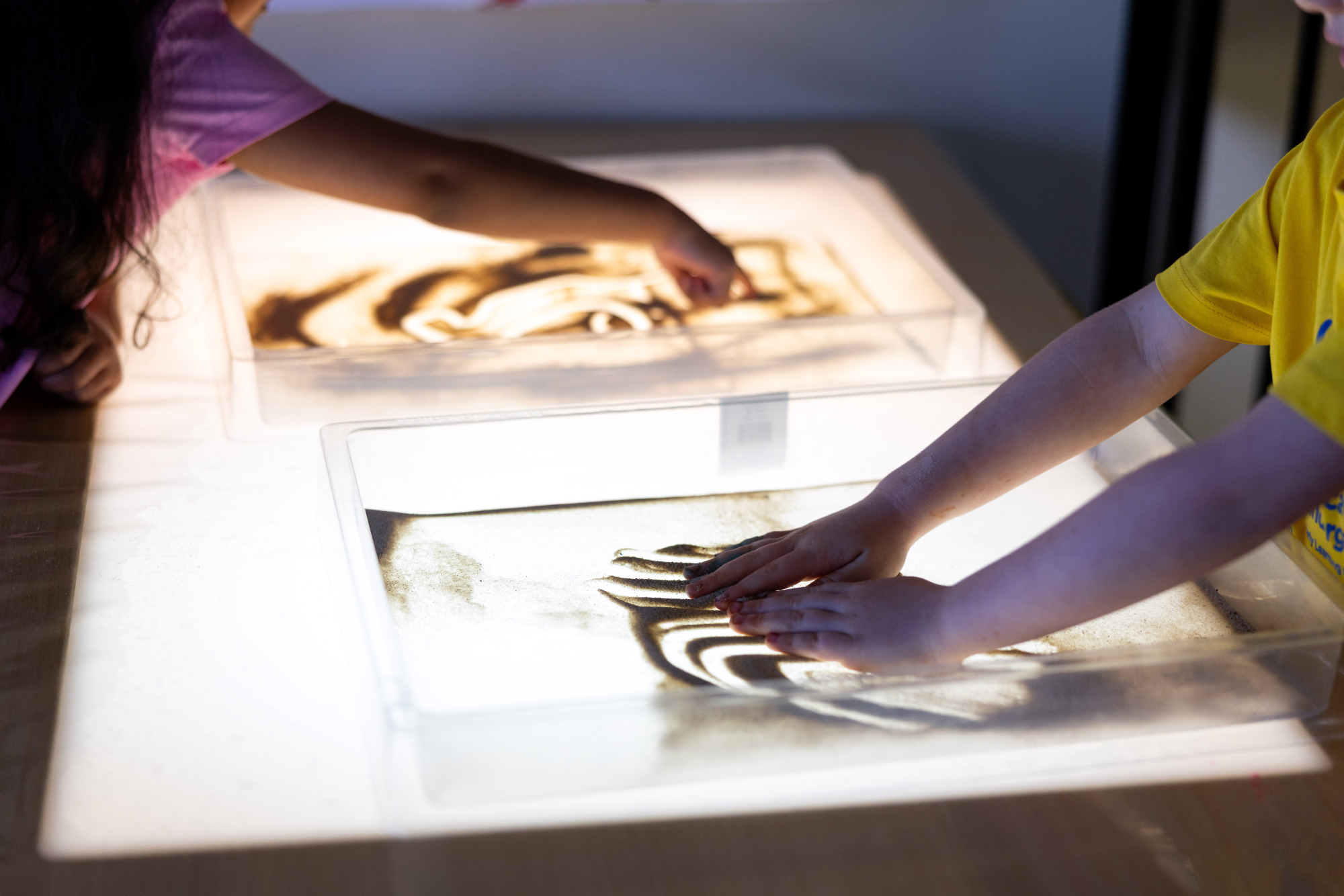 C&K Fairview Heights - children playing with sand on a light box