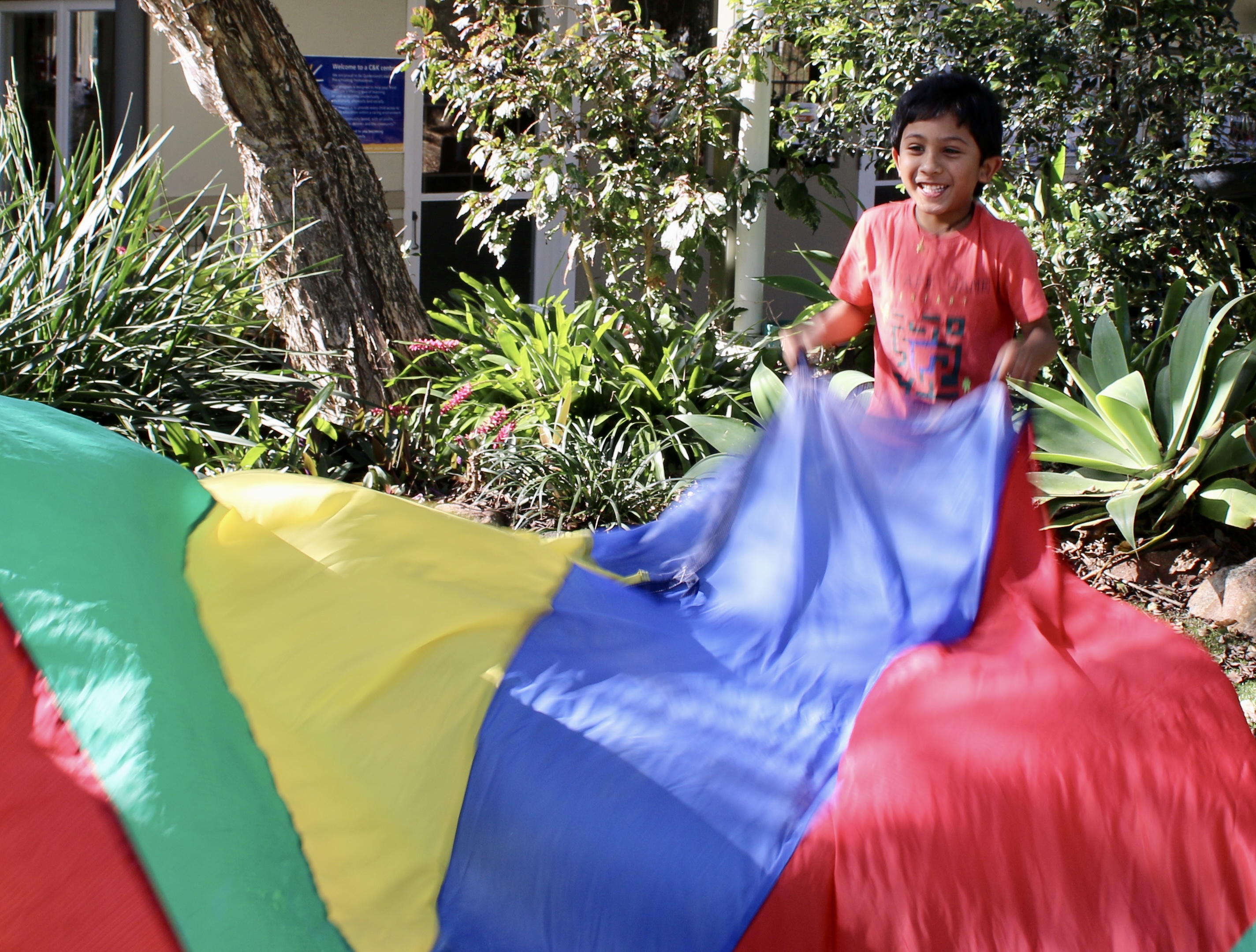 St Lucia Kindergarten boy playing with parachute