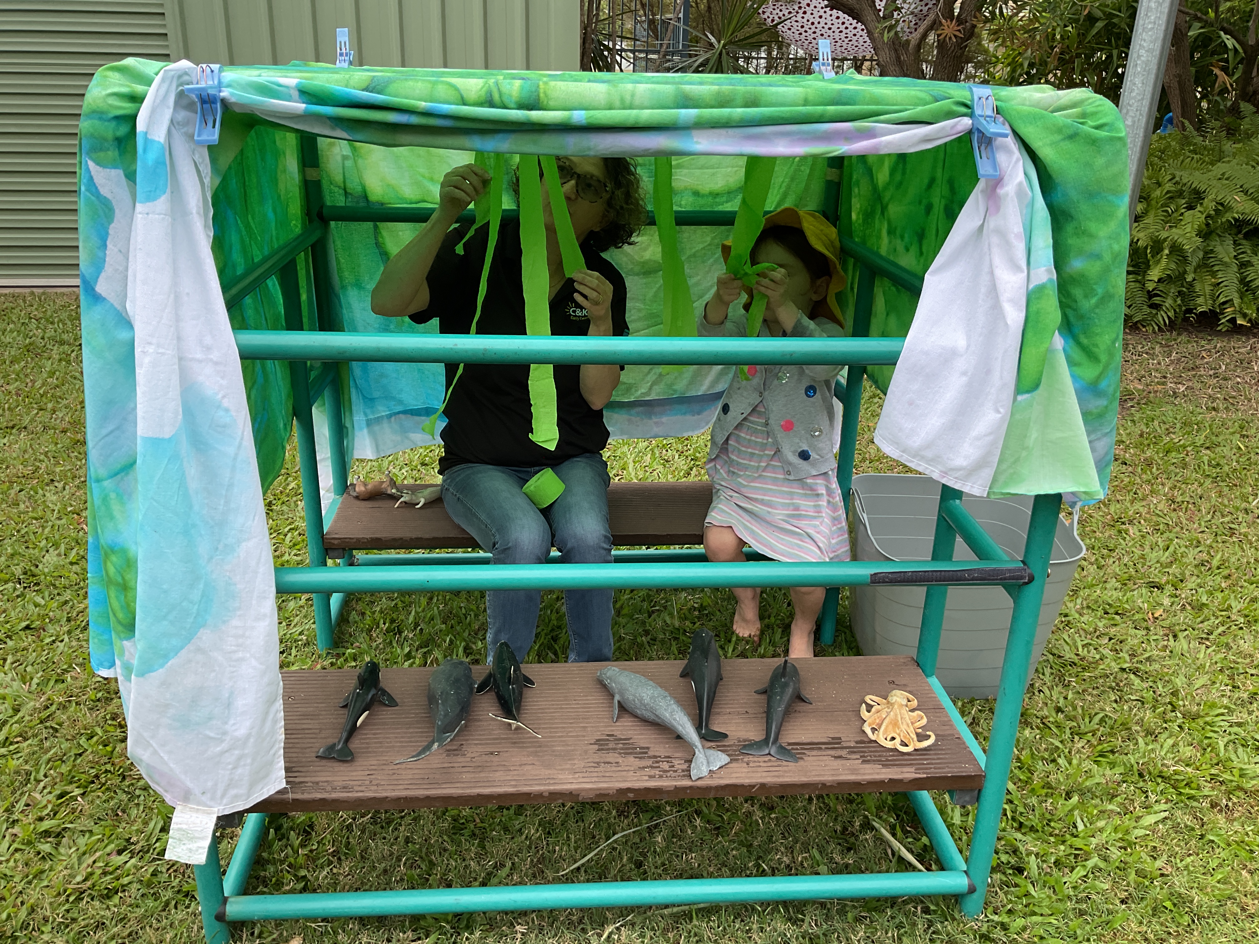 C&K Oonoonba - educator and child creating an underwater cave