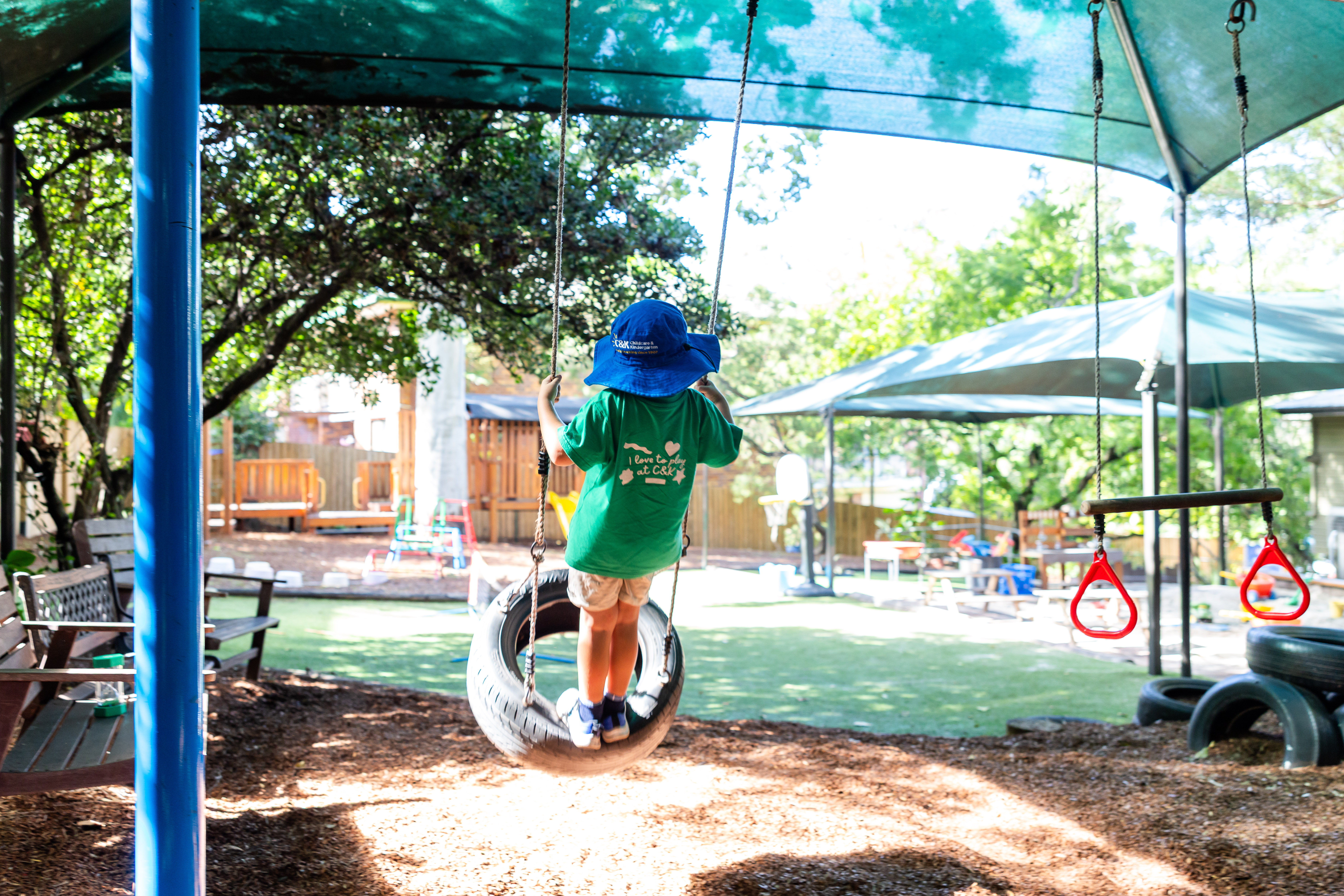 C&K Indooroopilly - child standing on a swing in motion
