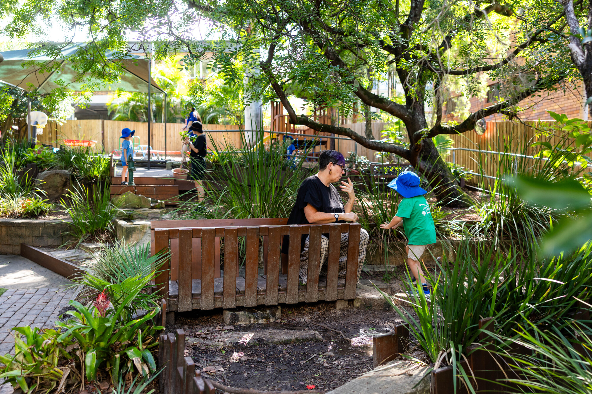 C&K Indooroopilly - educators and children in the outdoor space