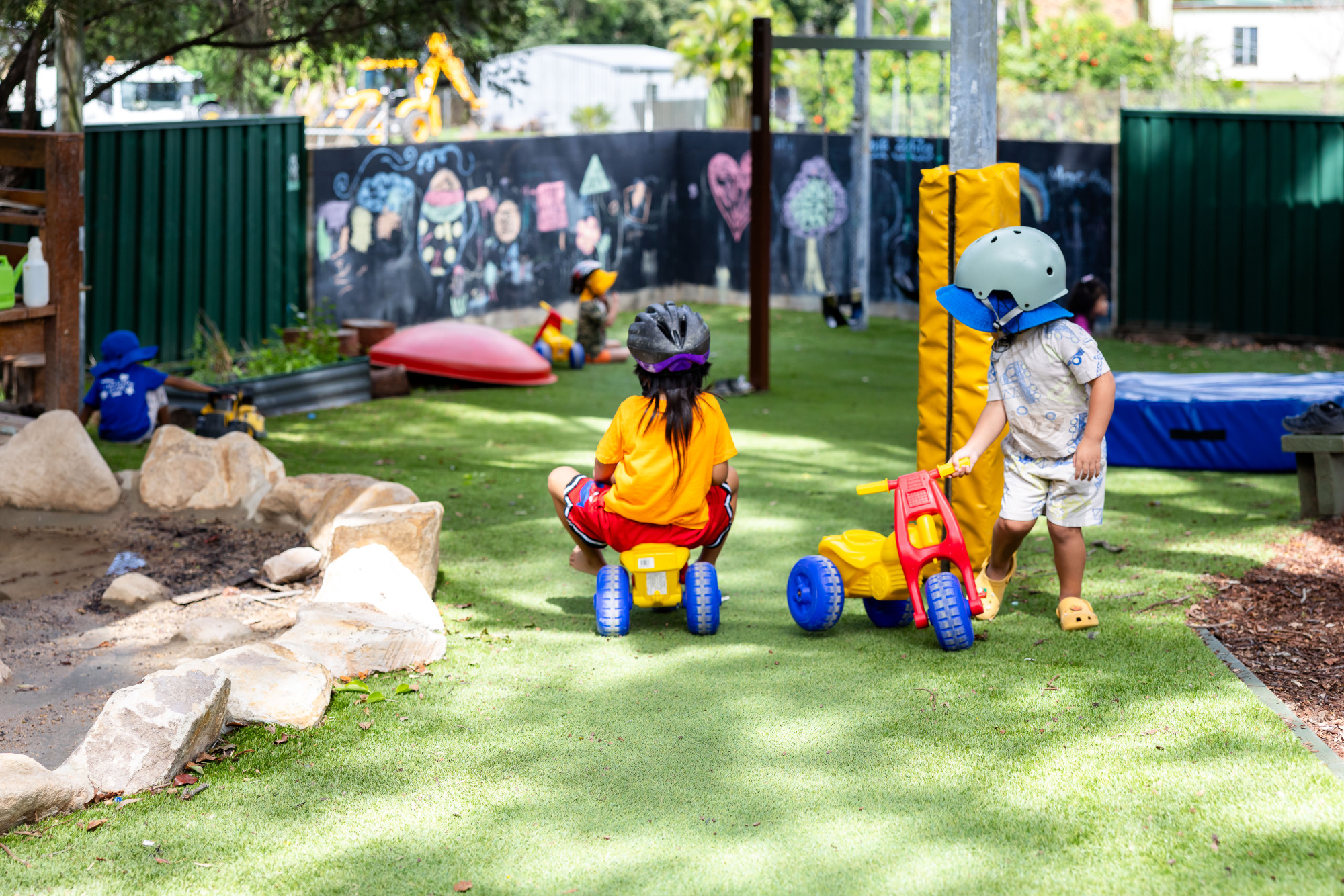 C&K Kilcoy - children riding down the hill on trikes