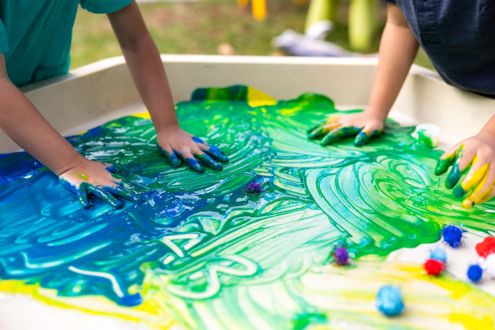 C&K Kilcoy - children engaging in messy play with paint and pom poms