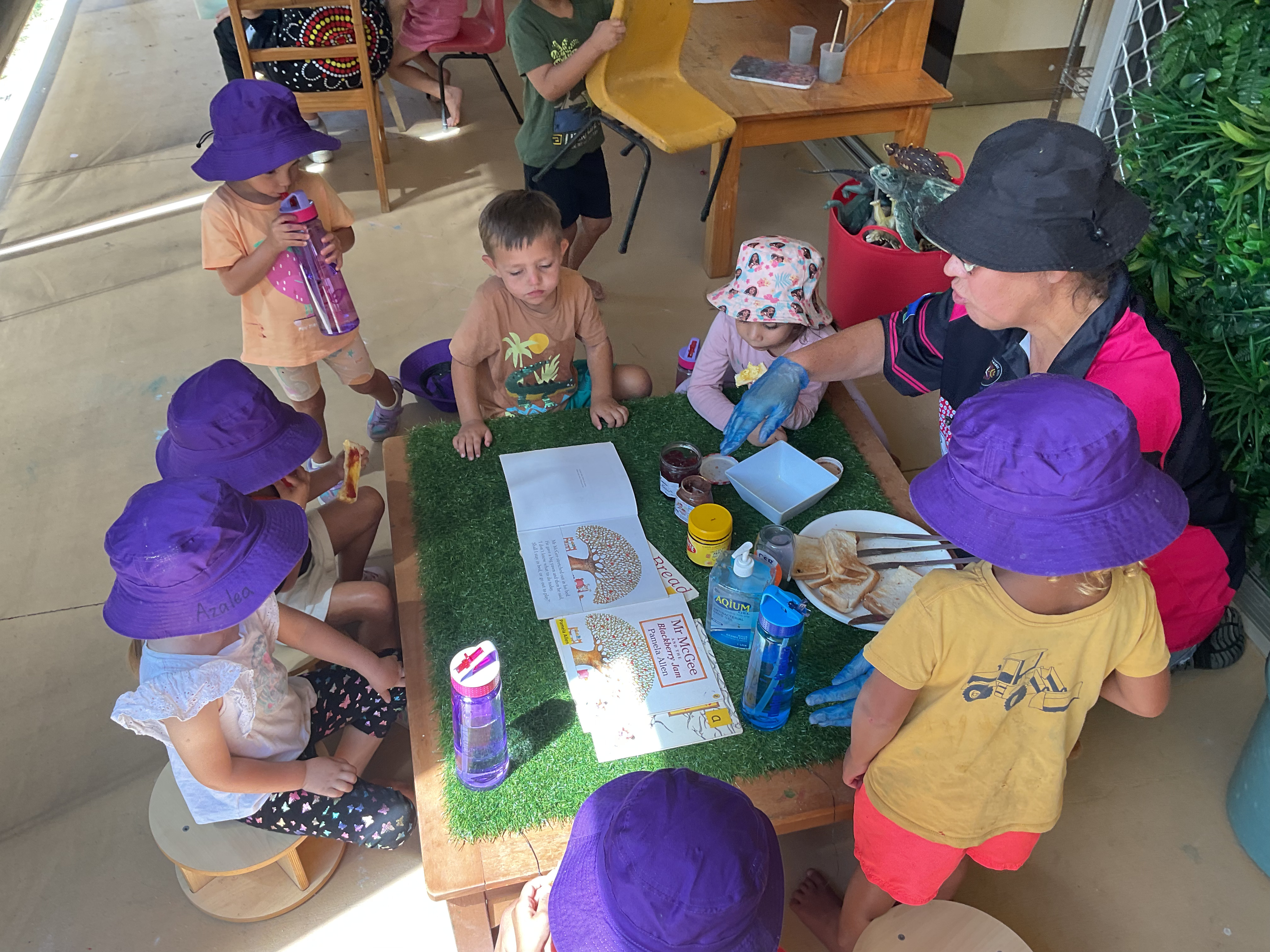 Educator and children making lunch together