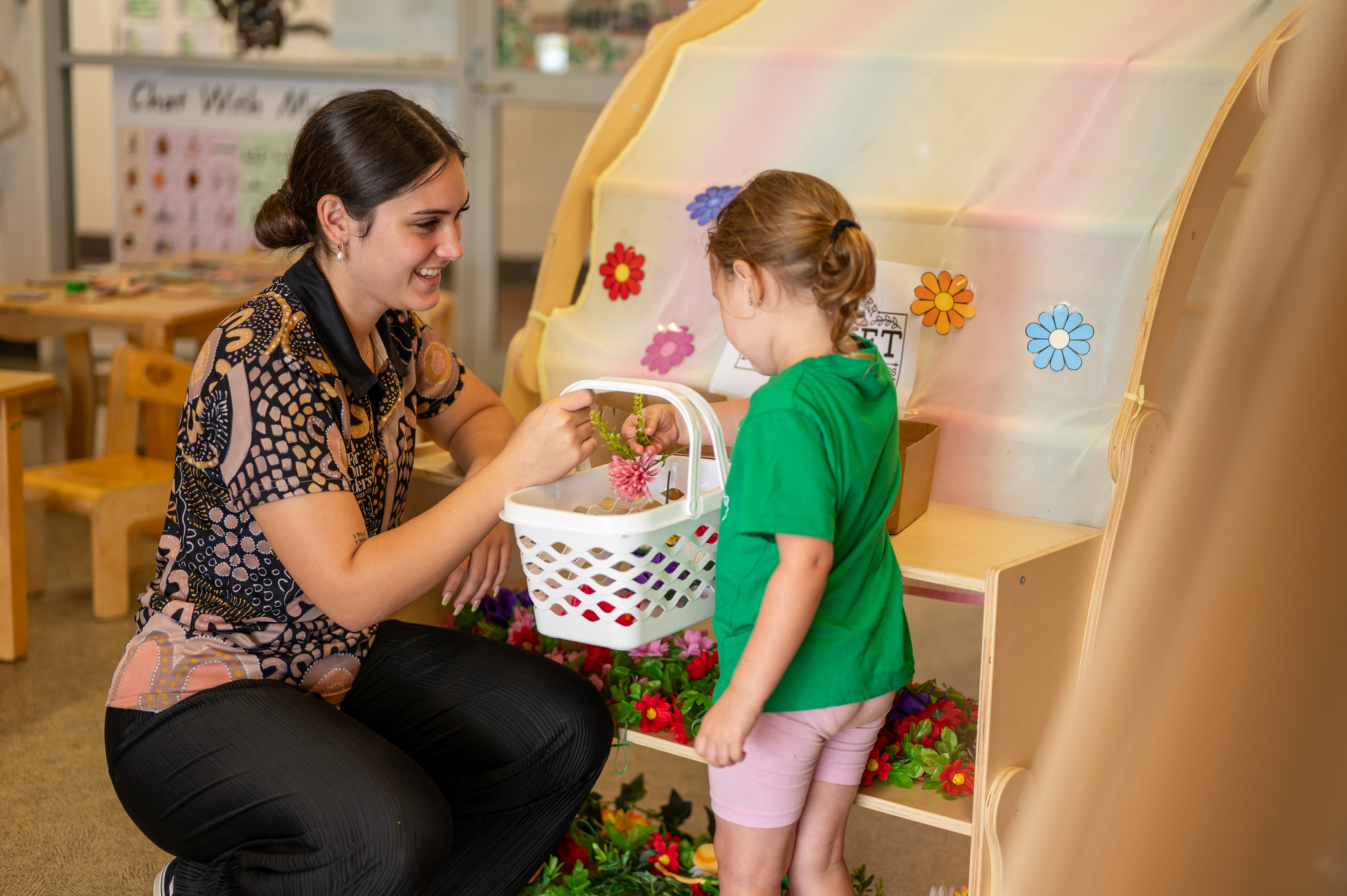 C&K Mackay CFC - educator and child role playing a flower market