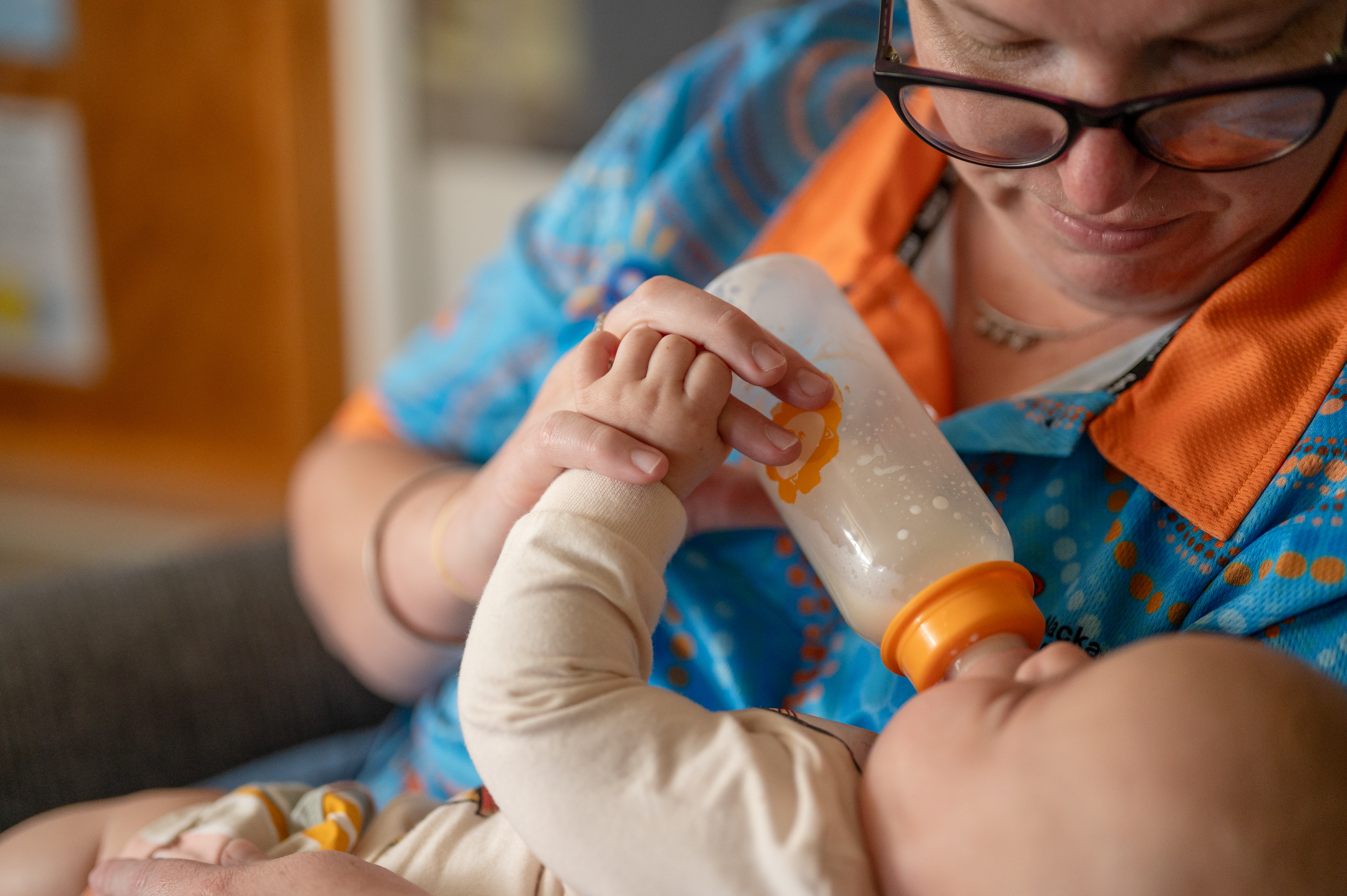 C&K Mackay CFC - educator giving an infant their bottle