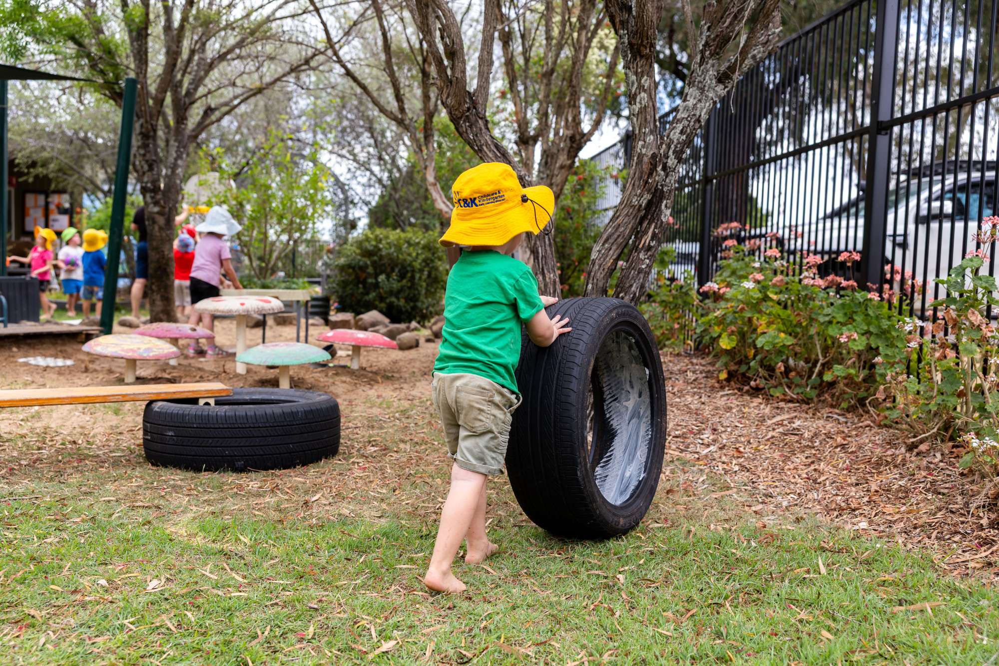 C&K Oakey - child pushing a tyre