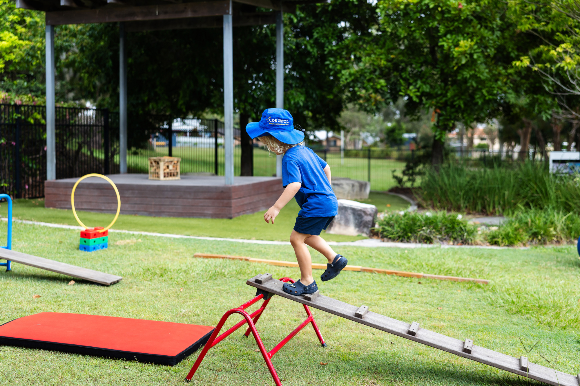 Child climbing the obstacle course outside
