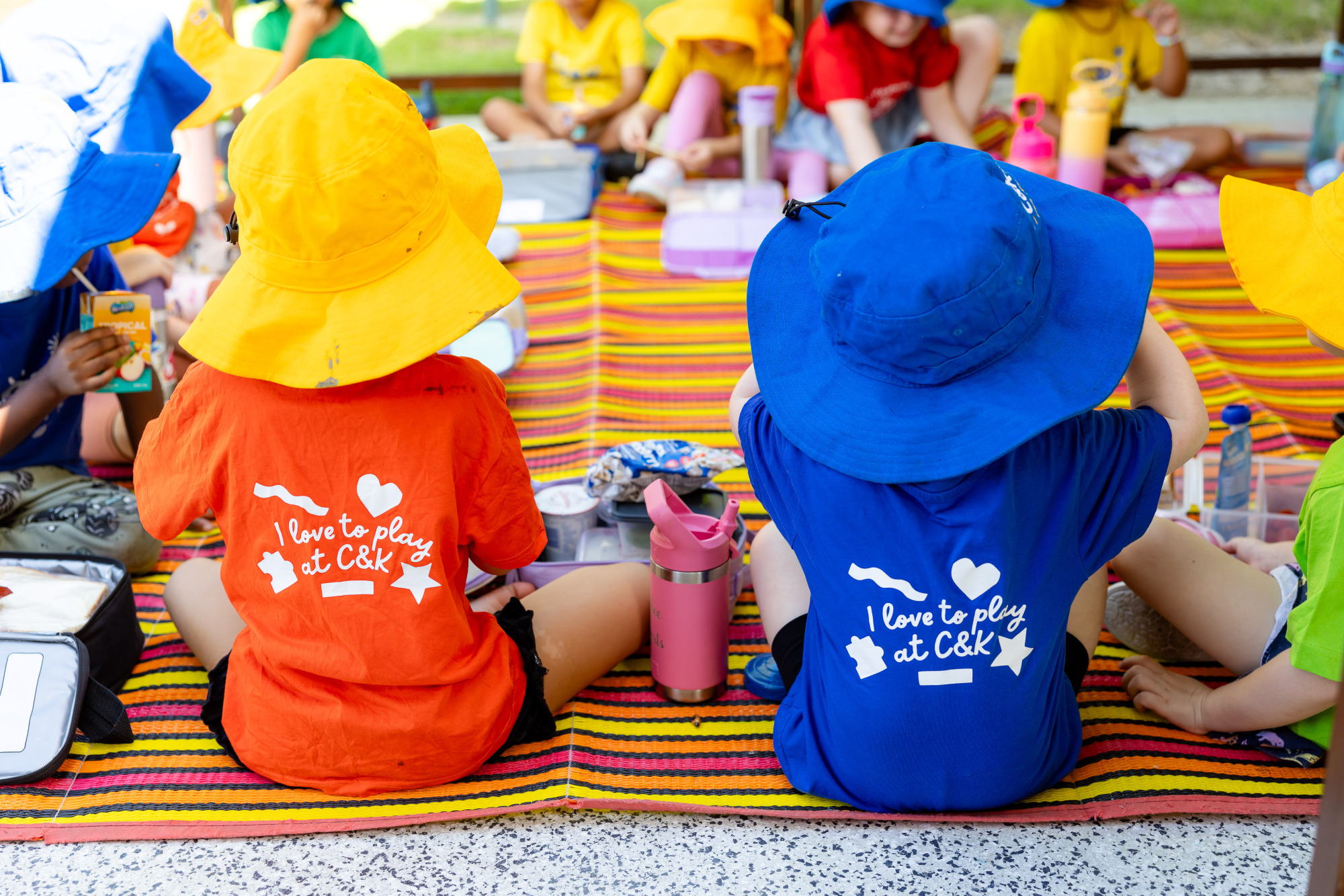 C&K Redbank Plains - children sitting in a circle outdoors eating lunch