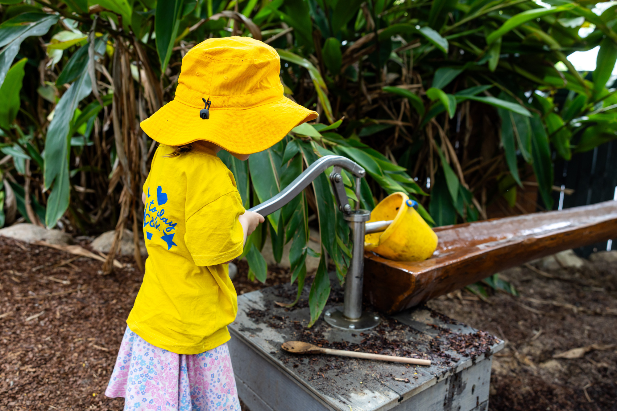 C&K Rosalie - child using a water pump outdoors