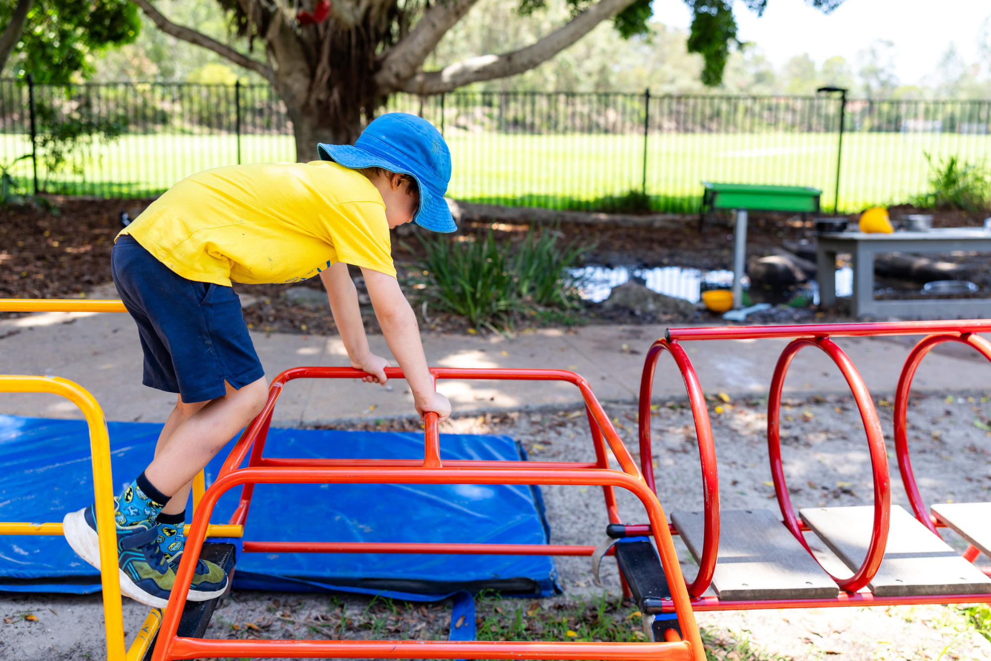 C&K Seven Hills - child climbing on obstacle course
