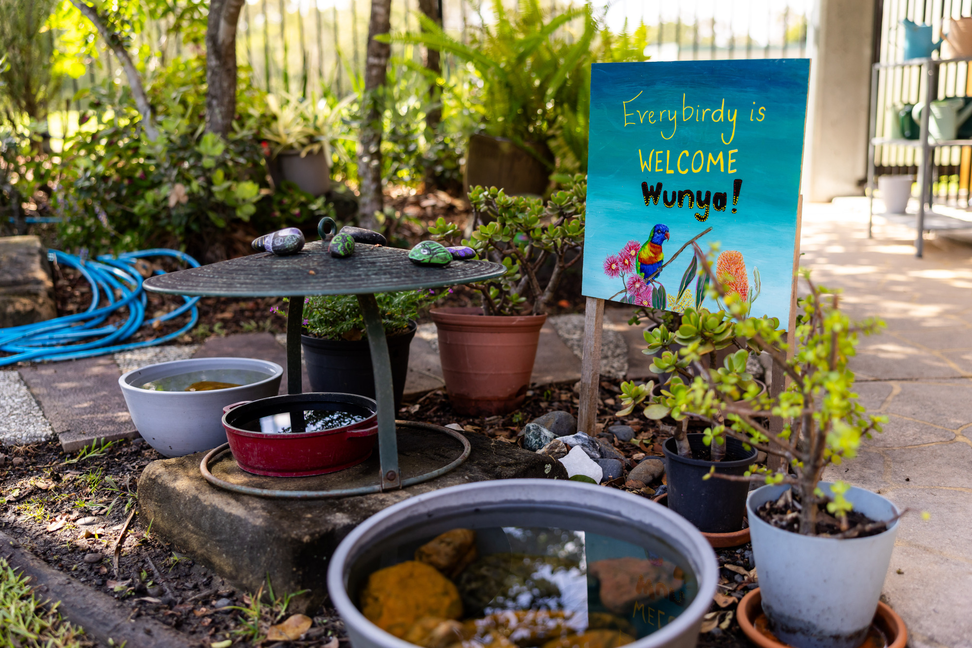 C&K Stretton - garden with a sign saying "everybirdy is welcome - wunya!"