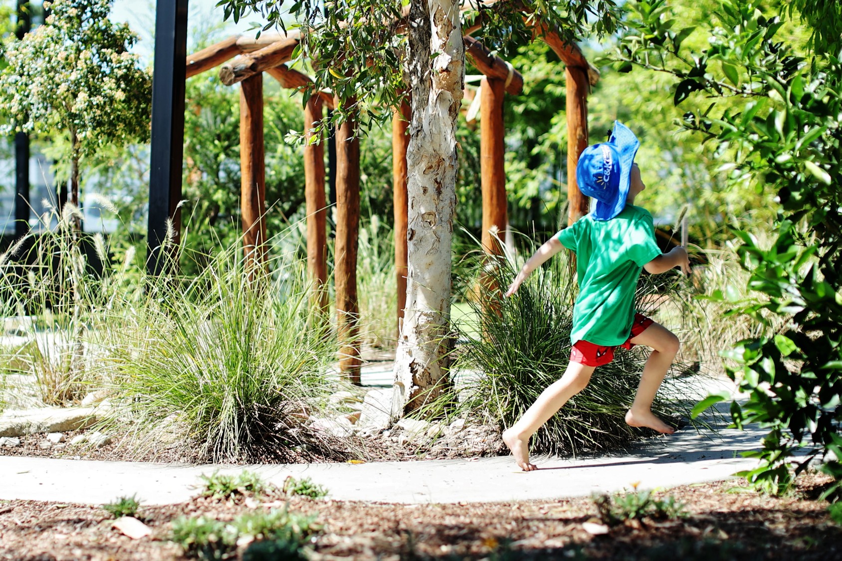 C&K Upper Kedron - child running along a path outside, surrounded by trees