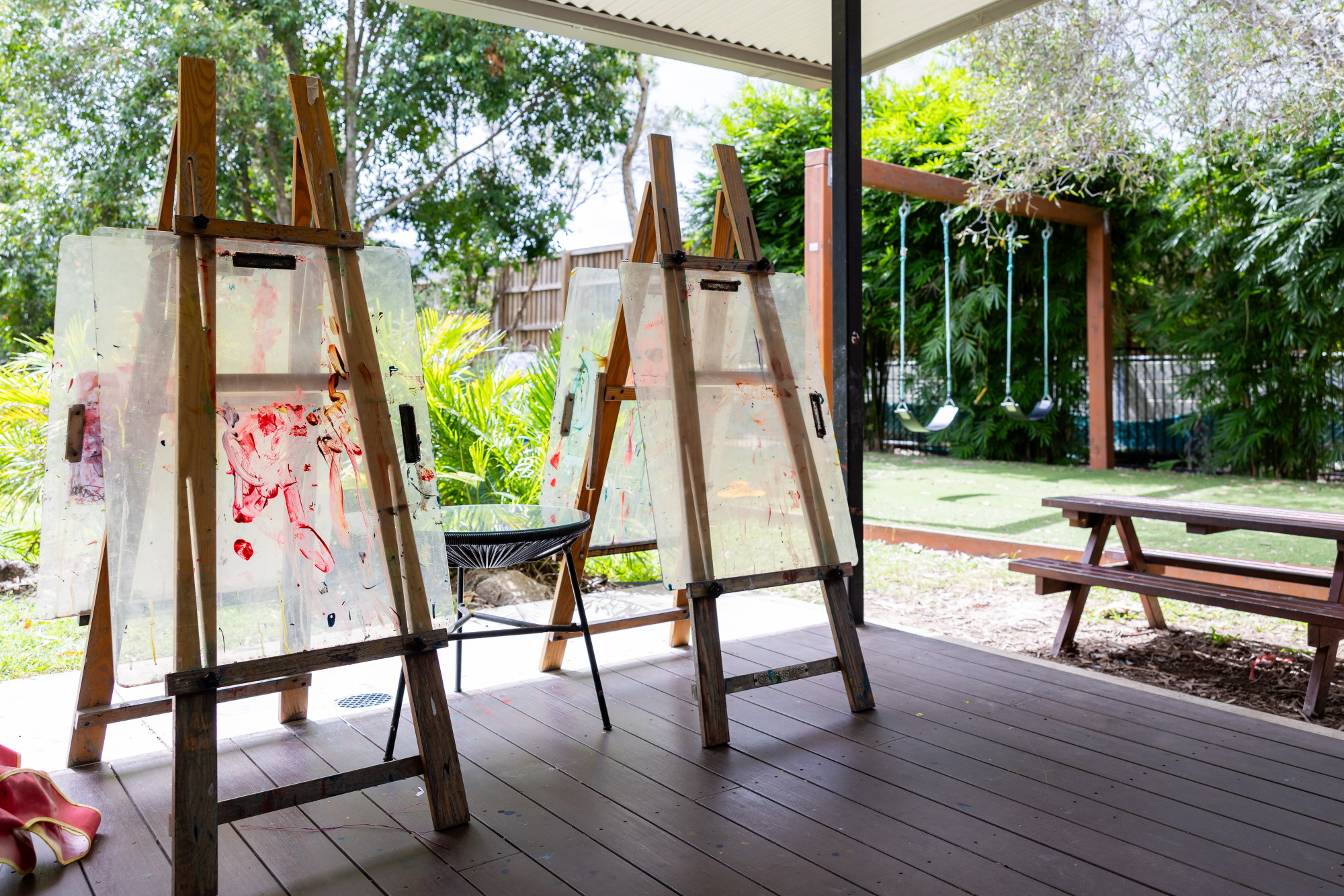 C&K Woodford - undercover outdoor space with art easels and swings in the background