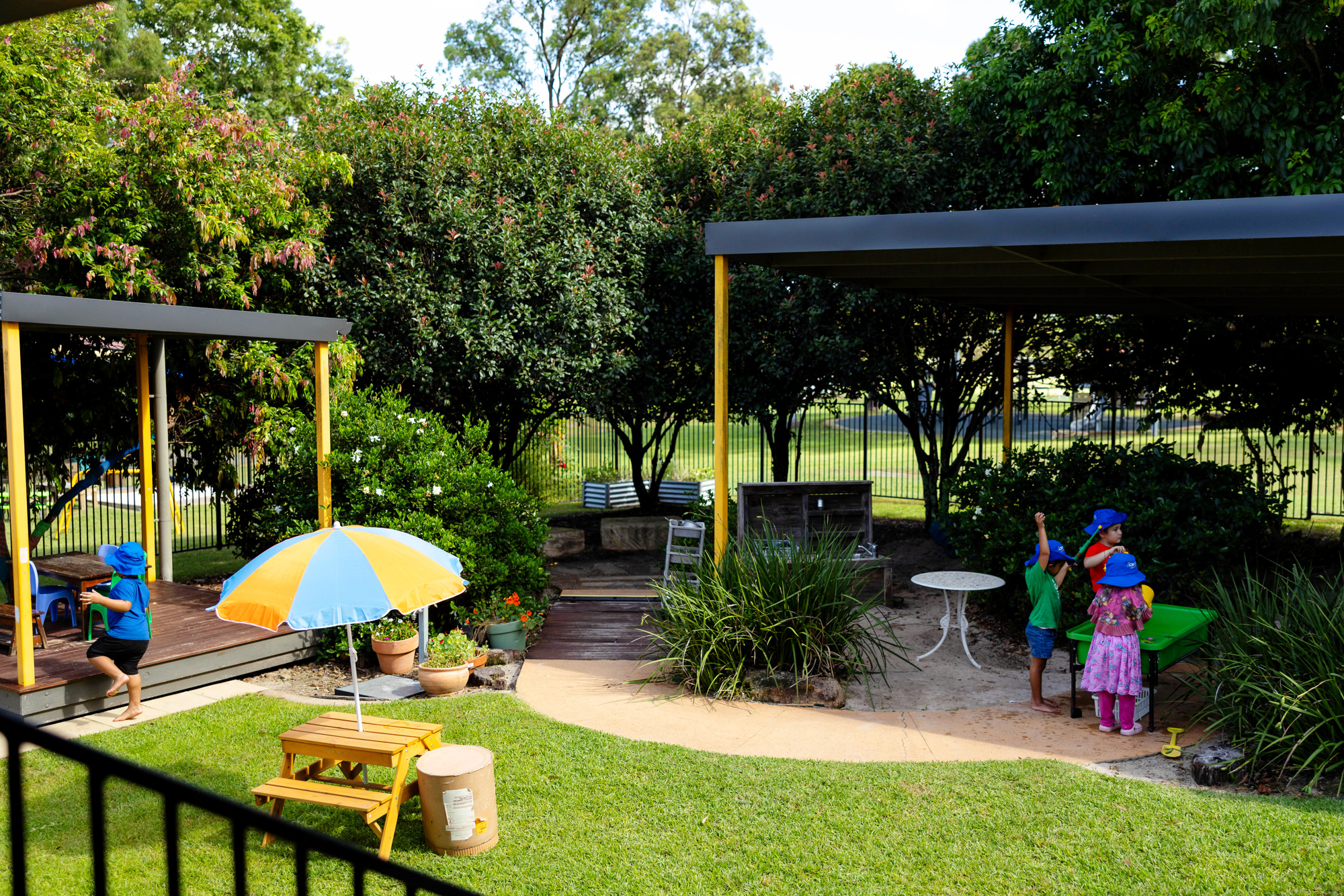 Children playing in large, green outdoor space