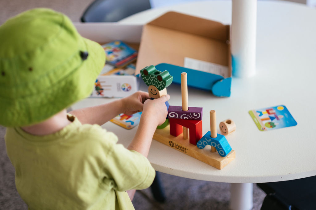Kindy child playing with wooden blocks