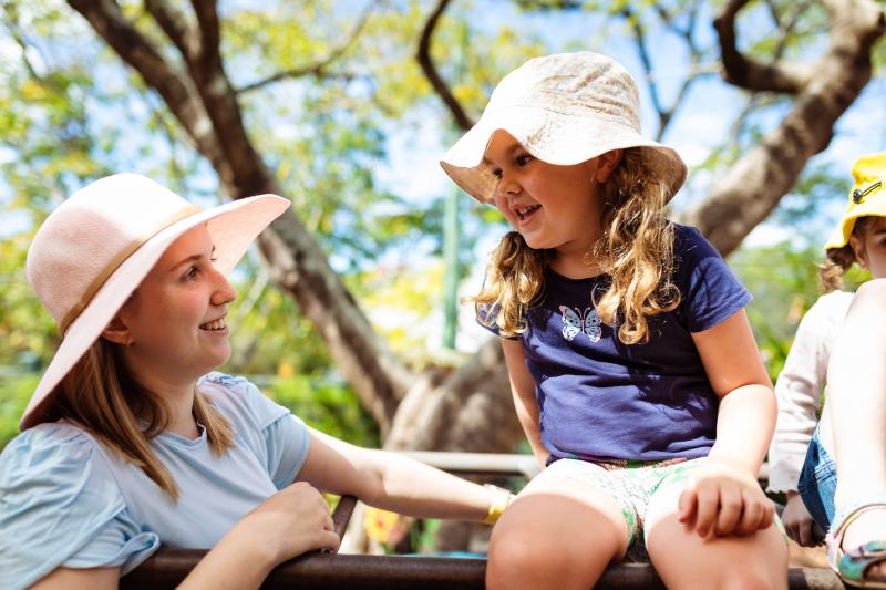 C&K Educator and child smiling outside