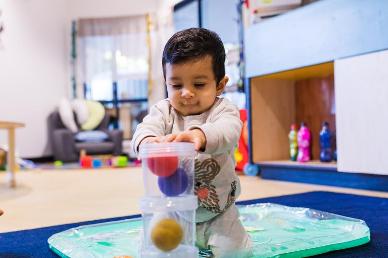 Baby playing with engaging toys