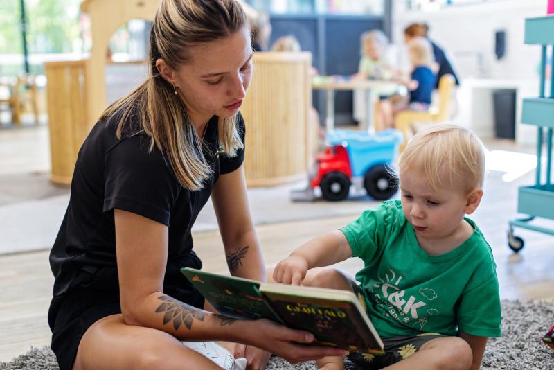 Educator reading with toddler
