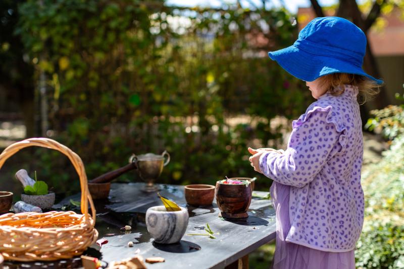Child playing outside creating with nature