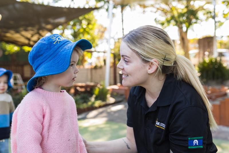Educator chatting to child outside