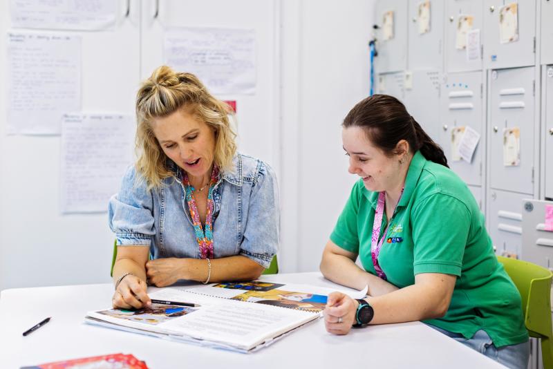 Educator and manager discussing program plans