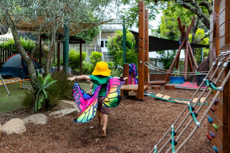 C&K kindy child running through playground as a butterfly