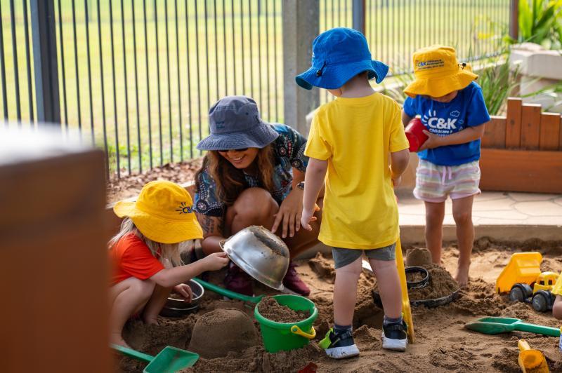 children and educator having fun in the sandpit at C&K Mackay CFC