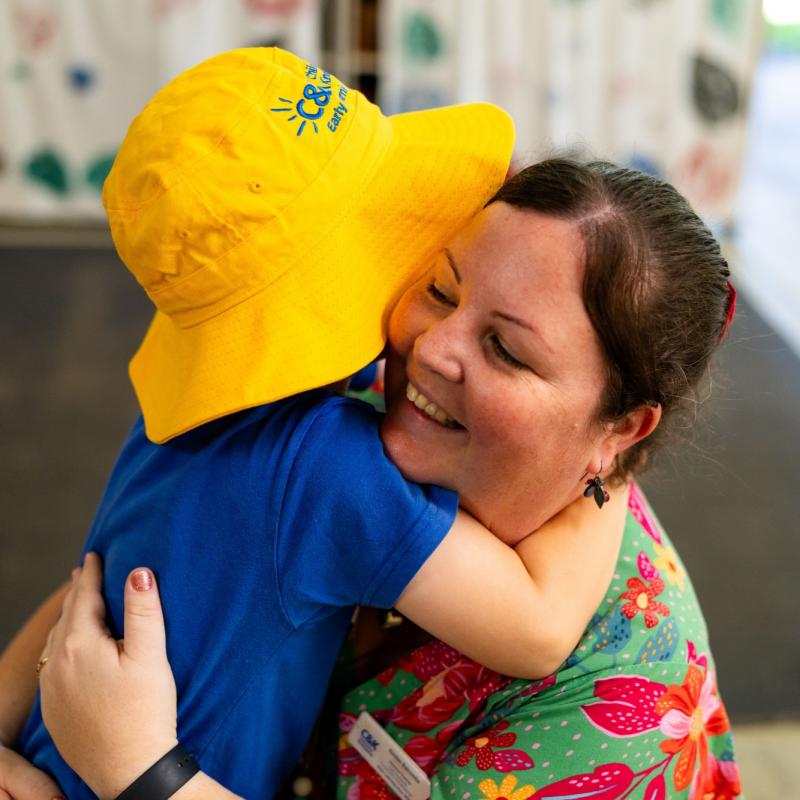 Child hugging an educator