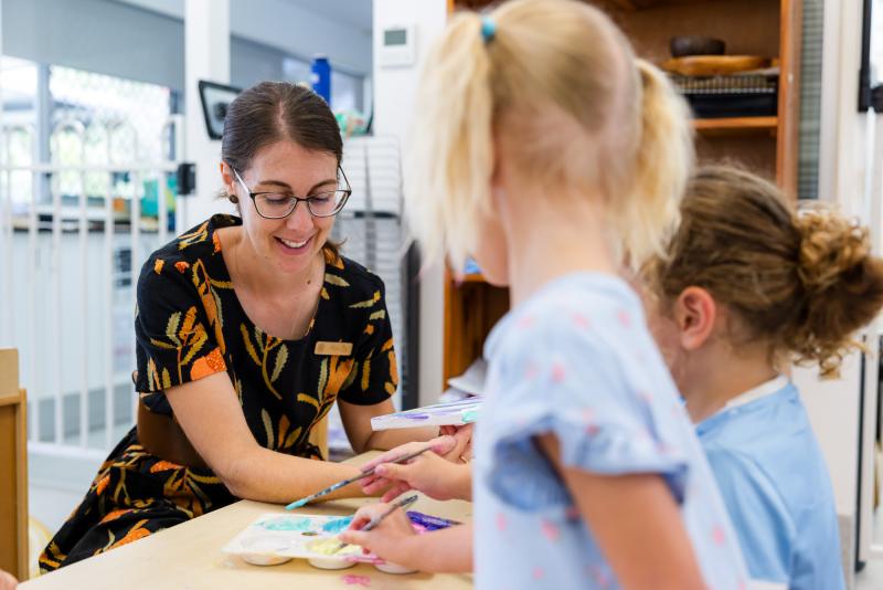 Educator engaging with children inside