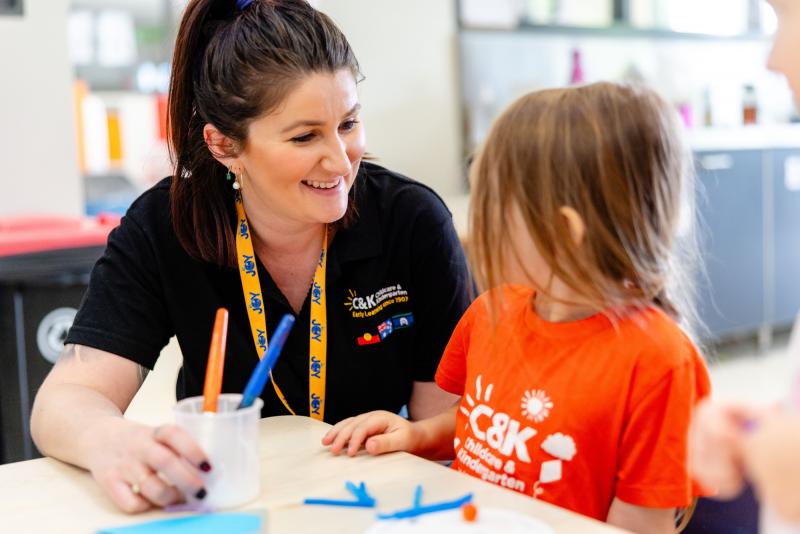 Educator smiling at a child