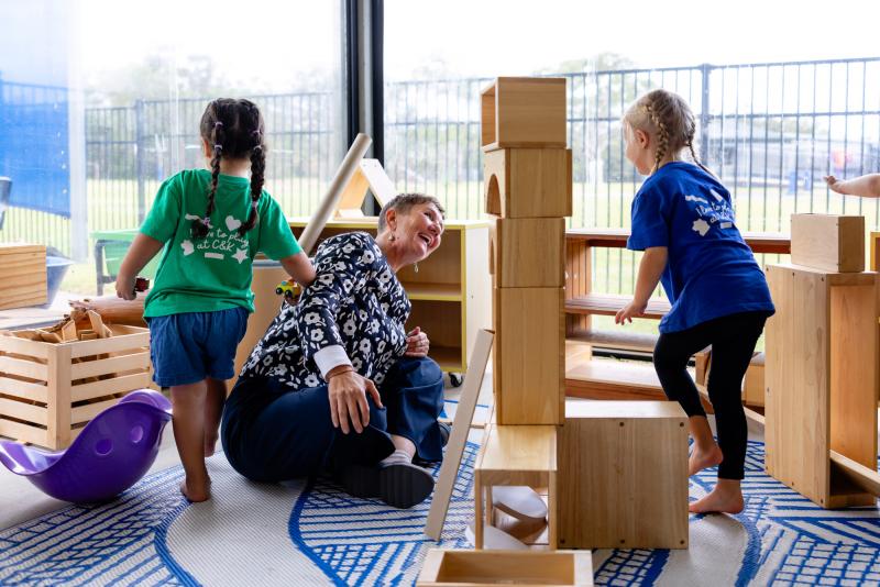 Kindy children and teacher building with blocks
