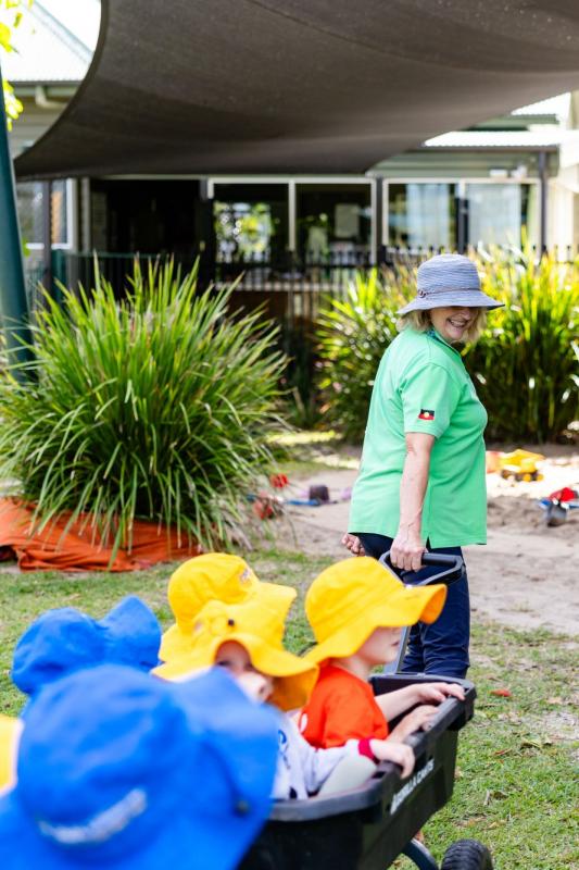 Kindy children and teacher playing outside