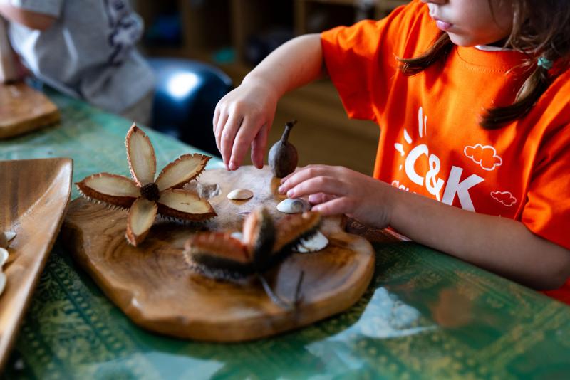 Kindy child playing with natural loose parts
